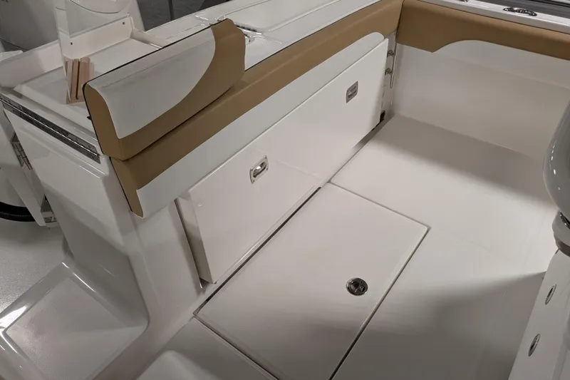 Slide: The Image of 2025 Regulator 25 boat interior with tan and white seating and storage compartments. - 27