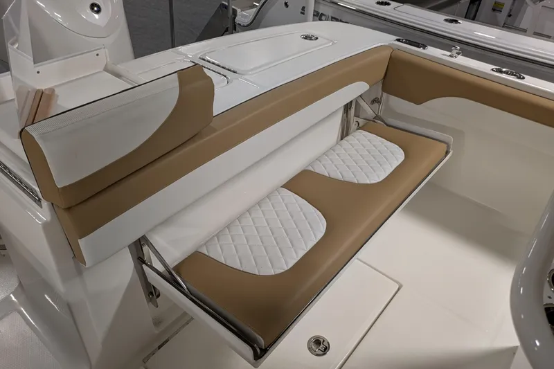 Slide: The Image of 2025 Regulator 25 boat interior with tan and white cushioned seating. - 28