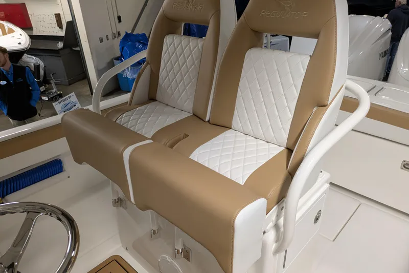 Slide: The Image of 2025 Regulator 25 boat seats with tan and white diamond stitching design. - 33
