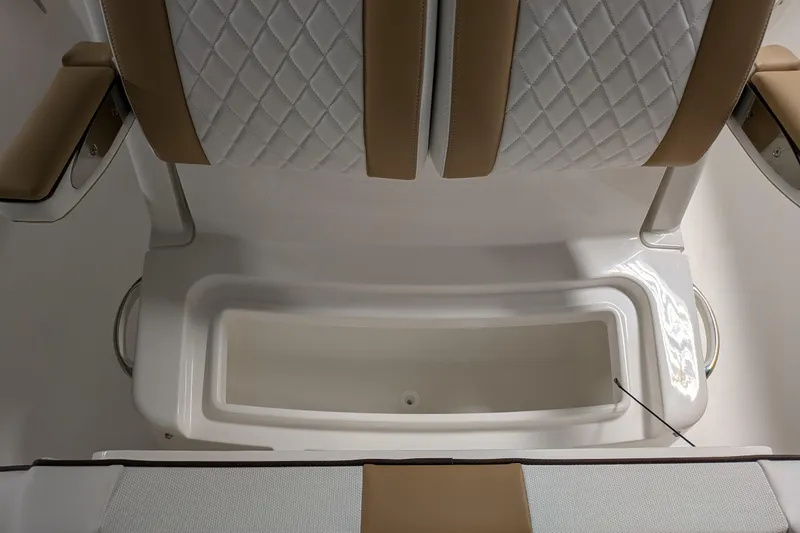 Slide: The Image of 2025 Regulator 25 boat seating with diamond-stitched upholstery and integrated storage compartment. - 37