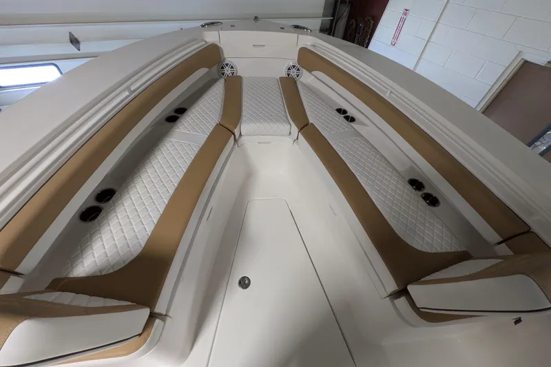 Slide: The Image of Luxurious seating area on 2025 Regulator 25 boat with tan and white upholstery. - 42