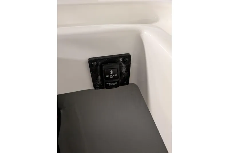 Slide: The Image of 2025 Regulator 25 boat windlass control switch on white panel. - 44