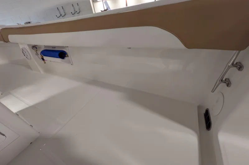 Slide: The Image of Interior view of a 2025 Regulator 25 boat, featuring sleek white surfaces and tan accents. - 48