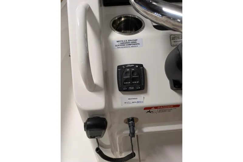 Slide: The Image of 2025 Regulator 25 boat control panel with switches and microphone. - 50