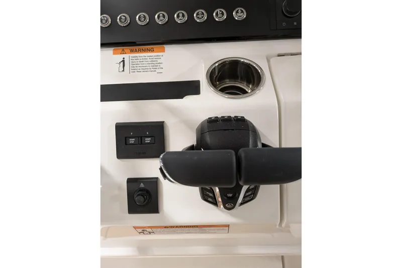 Slide: The Image of Control panel of 2025 Regulator 25 boat with steering and switches. - 51