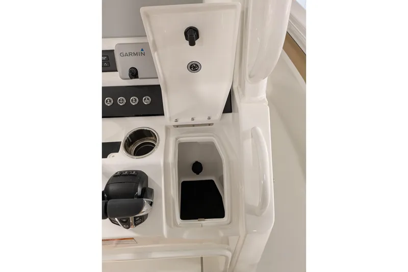 Slide: The Image of Center console of 2025 Regulator 25 boat with Garmin electronics and storage compartment. - 52