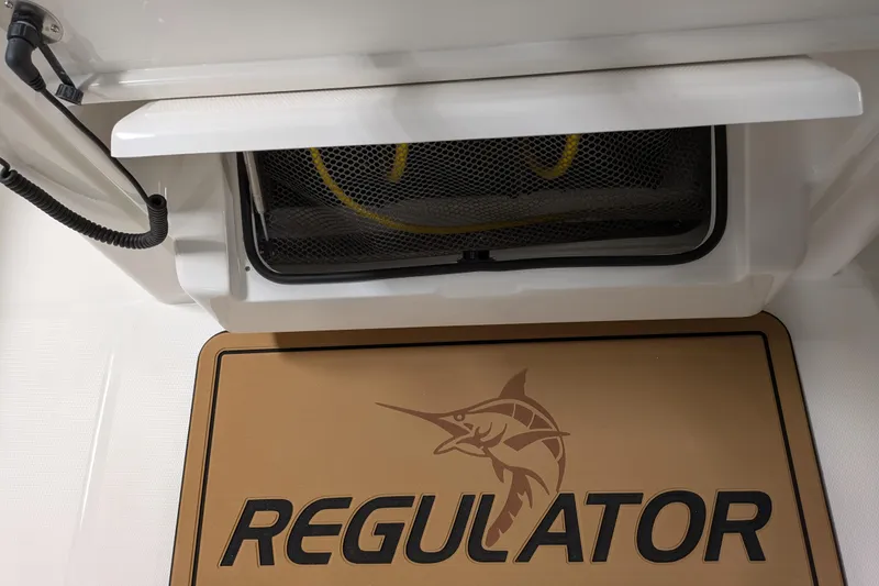 Slide: The Image of 2025 Regulator 25 boat interior with logo mat and storage compartment. - 53