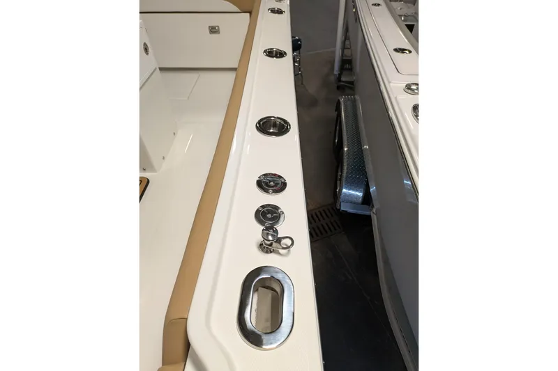 Slide: The Image of 2025 Regulator 25 boat interior with cup holders and sleek design. - 54