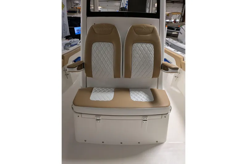 Slide: The Image of 2025 Regulator 25 boat seats with tan and white quilted upholstery. - 56