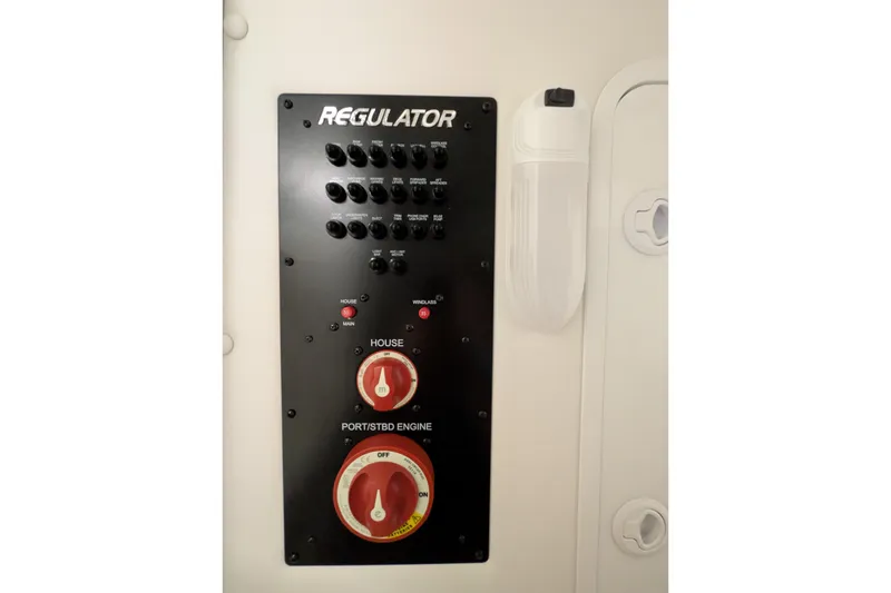 Slide: The Image of Control panel of a 2025 Regulator 25 boat with switches and dials. - 63
