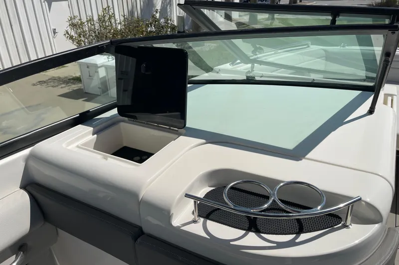 Slide: The Image of 2023 Sea Ray SDX 290 Outboard boat dashboard with cup holders and storage compartment. - 10