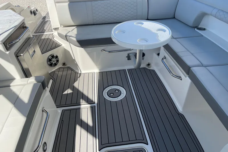 Slide: The Image of 2023 Sea Ray SDX 290 Outboard boat interior with seating and table. - 14