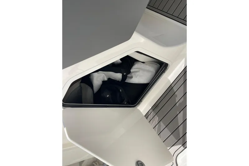 Slide: The Image of Storage compartment on 2023 Sea Ray SDX 290 Outboard boat, open with items inside. - 17