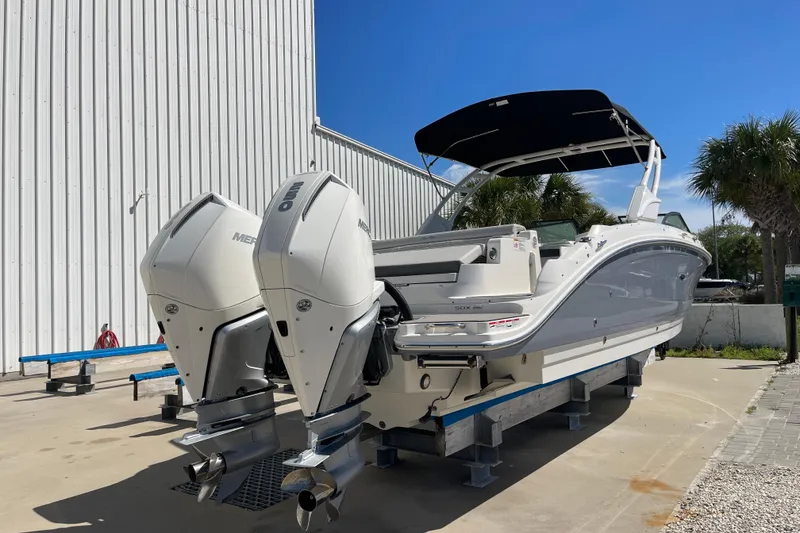 Slide: The Image of 2023 Sea Ray SDX 290 Outboard boat with dual engines on display. - 2