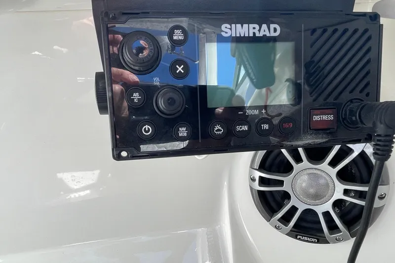 Slide: The Image of Simrad marine radio and speaker on 2023 Sea Ray SDX 290 Outboard boat. - 25