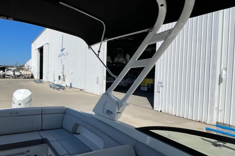 Slide: The Image of 2023 Sea Ray SDX 290 Outboard boat interior at a marina with storage facility. - 26