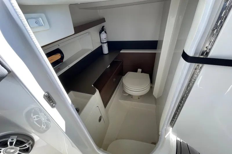 Slide: The Image of 2023 Sea Ray SDX 290 Outboard boat interior with compact bathroom and modern amenities. - 32