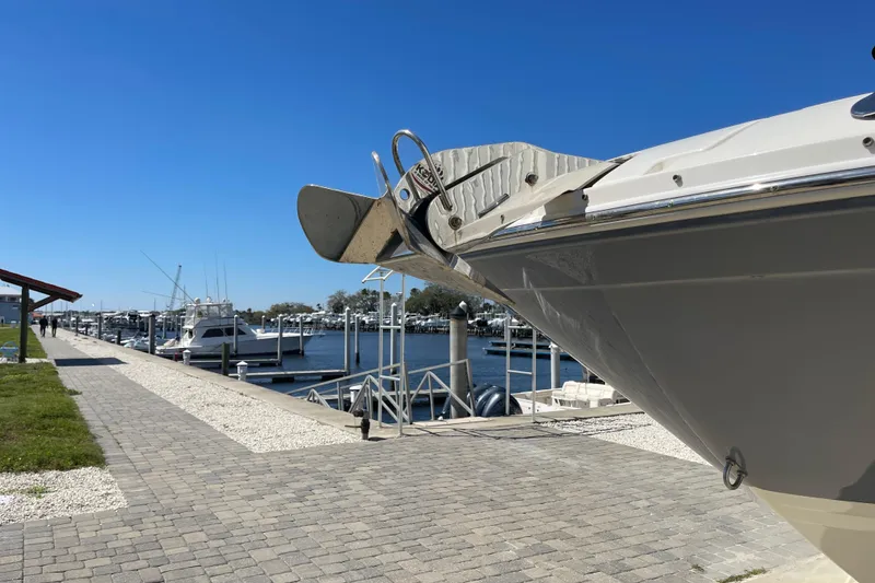 Slide: The Image of 2023 Sea Ray SDX 290 Outboard docked at a marina under clear blue skies. - 4