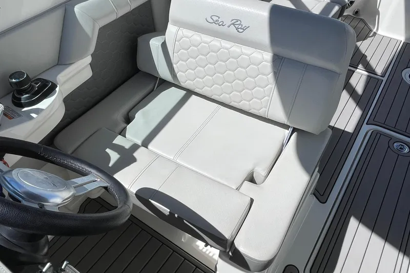 Slide: The Image of 2023 Sea Ray SDX 290 Outboard cockpit with luxurious seating and modern steering wheel. - 9
