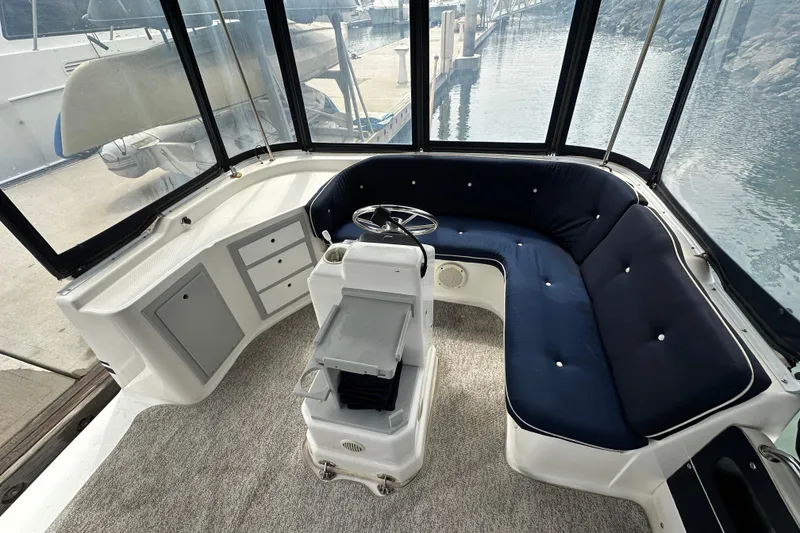 Slide: The Image of Interior of a 2012 ElectraCraft CAT 16 boat with blue seating and steering console. - 10