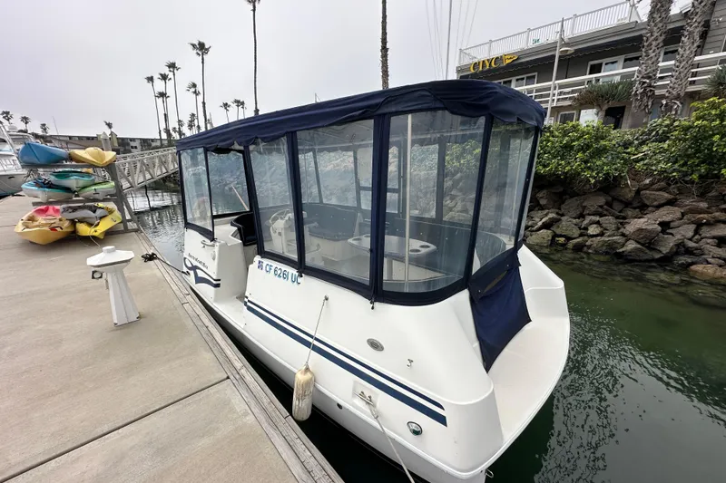 Slide: The Image of 2012 ElectraCraft CAT 16 boat docked near colorful kayaks and palm trees. - 3
