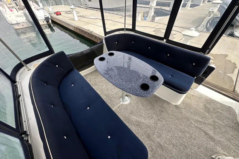 Slide: The Image of Luxurious seating area on a 2012 ElectraCraft CAT 16 boat with a stylish table. - 8