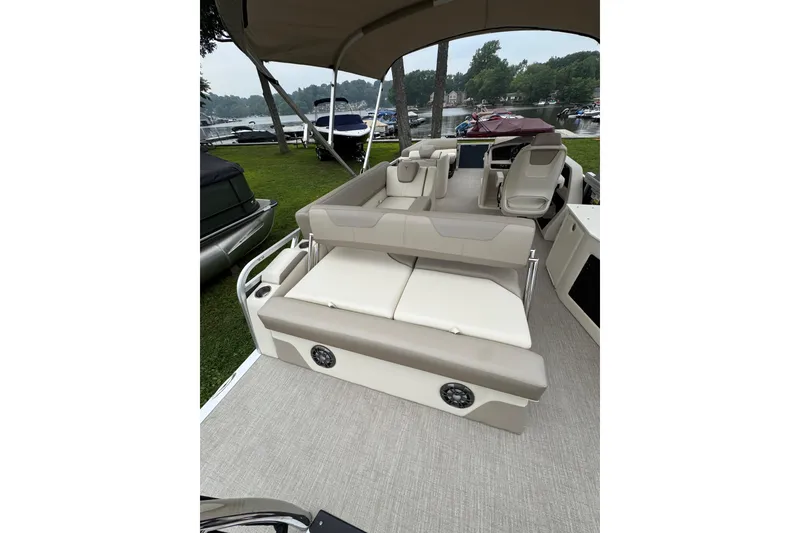 Slide: The Image of 2026 Tahoe Pontoon LTZ CRB interior with beige seating and lake view. - 9