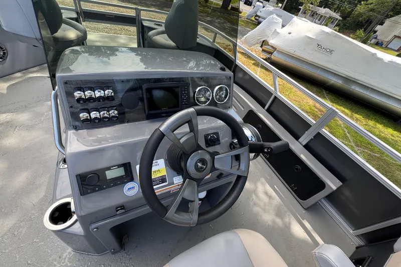 Slide: The Image of 2026 Tahoe Pontoon Sport 85 Center Console Fish 23 dashboard with steering wheel and controls. - 6