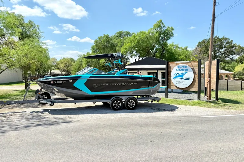 The Image of 2016 Nautique Super Air Nautique G23 boat on trailer at Elite Marine dealership. - 1