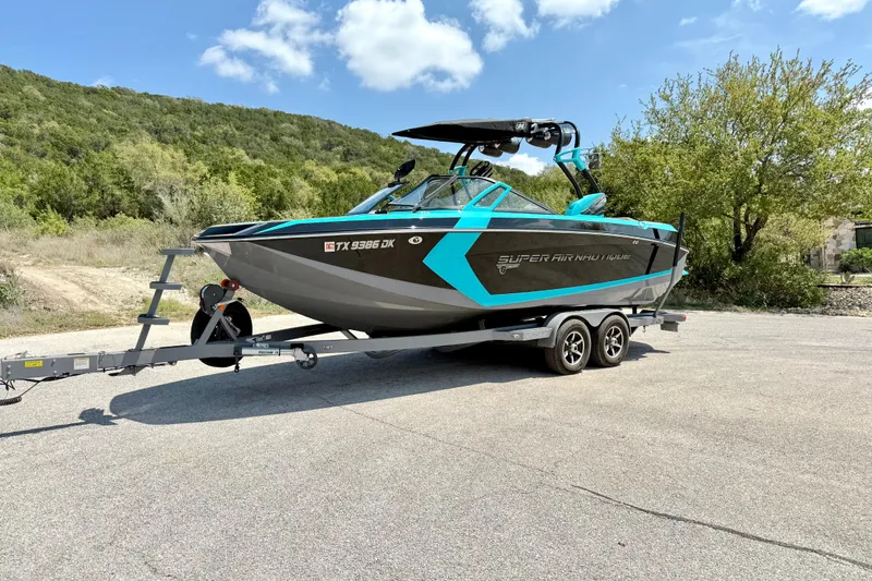 Slide: The Image of 2016 Nautique Super Air Nautique G23 boat on trailer, parked outdoors. - 10