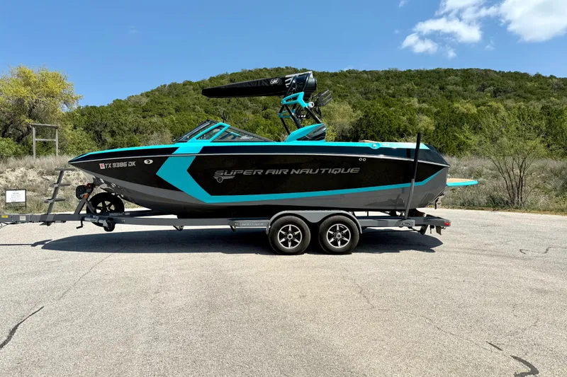 Slide: The Image of 2016 Nautique Super Air Nautique G23 boat on trailer, parked outdoors. - 11