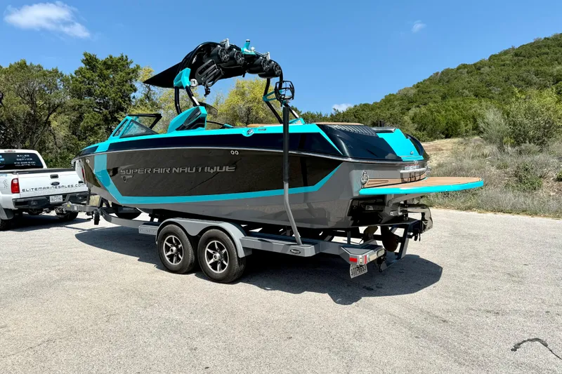 Slide: The Image of 2016 Nautique Super Air Nautique G23 boat on trailer, parked outdoors. - 12
