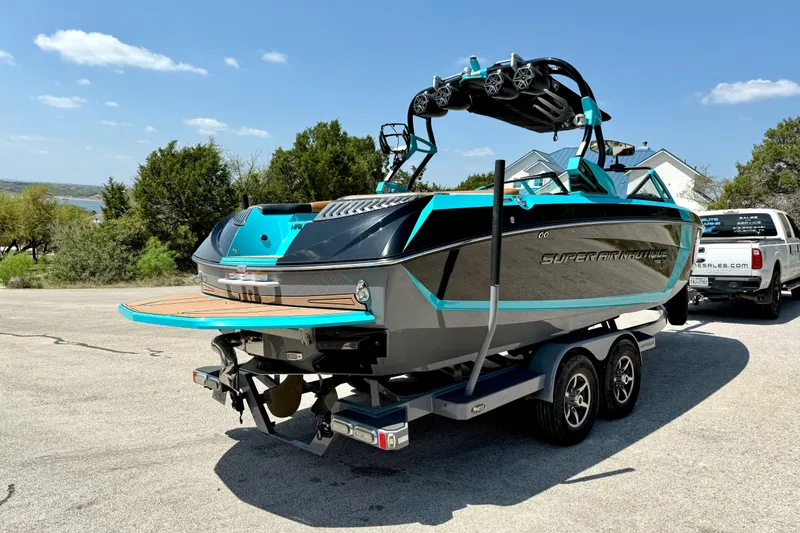 Slide: The Image of 2016 Nautique Super Air Nautique G23 boat on trailer, parked outdoors. - 15