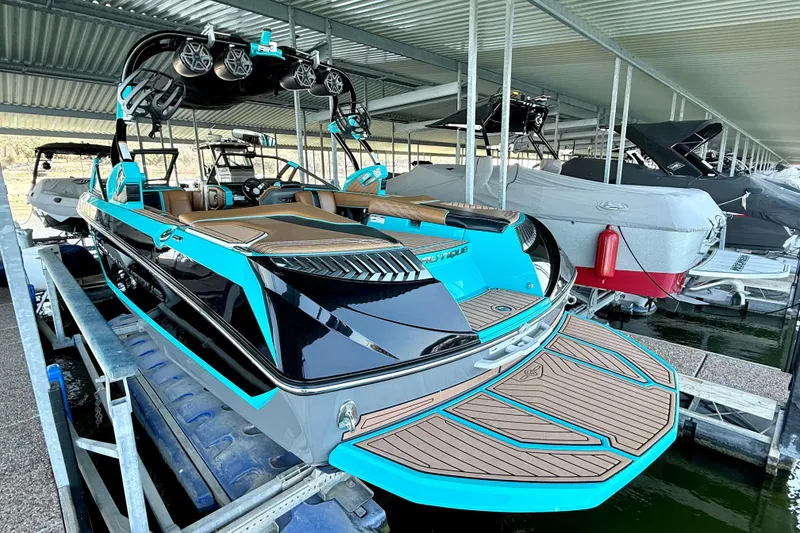 Slide: The Image of 2016 Nautique Super Air Nautique G23 boat docked, featuring sleek design and vibrant colors. - 21