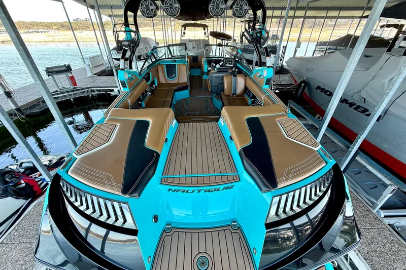 Slide: The Image of 2016 Nautique Super Air Nautique G23 boat with sleek design and spacious interior. - 23