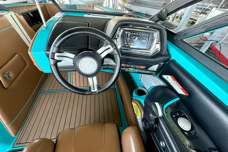 Slide: The Image of 2016 Nautique Super Air Nautique G23 dashboard with steering wheel and control panel. - 30
