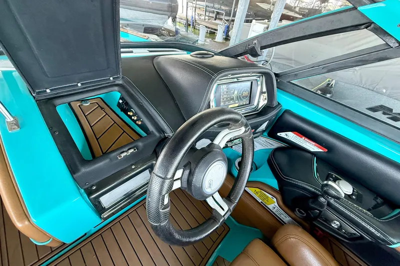 Slide: The Image of Interior of 2016 Nautique Super Air Nautique G23 boat with steering wheel and dashboard. - 31
