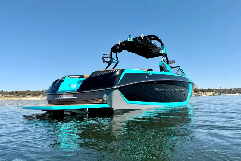Slide: The Image of 2016 Nautique Super Air Nautique G23 boat on calm water, showcasing sleek design and vibrant colors. - 4