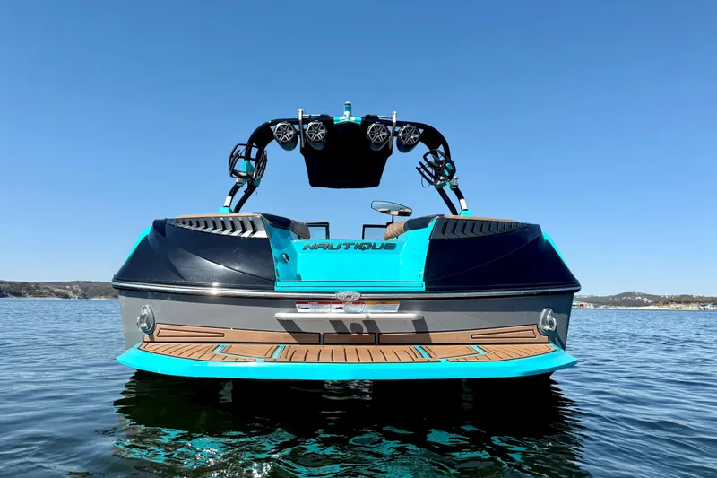 Slide: The Image of 2016 Nautique Super Air Nautique G23 boat on water, rear view, clear sky. - 5