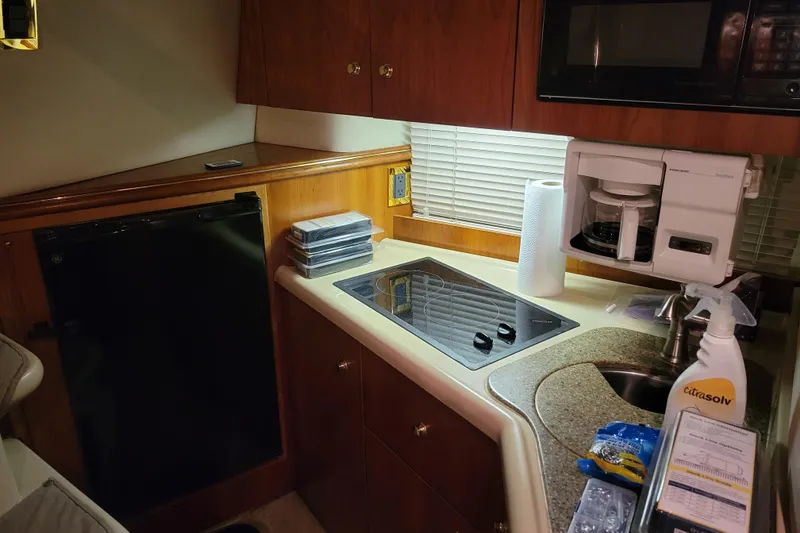 Slide: The Image of 2000 Cruisers Yachts 3375 Express kitchen with stove, sink, and coffee maker. - 8