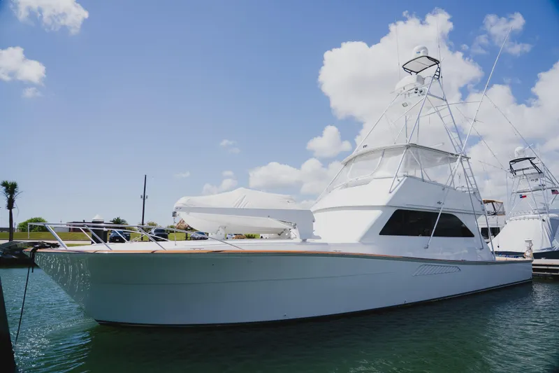 The Image of 1999 Viking 58 Convertible yacht docked under a clear blue sky. - 0