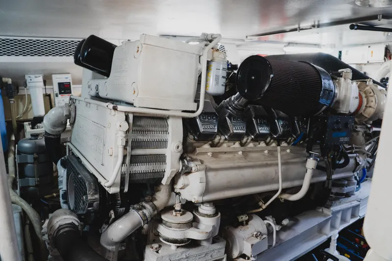 Slide: The Image of Engine room of a 1999 Viking 58 Convertible yacht, showcasing a powerful marine engine. - 100