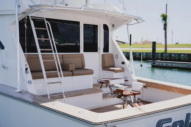 Slide: The Image of 1999 Viking 58 Convertible yacht with seating area and fishing equipment. - 11