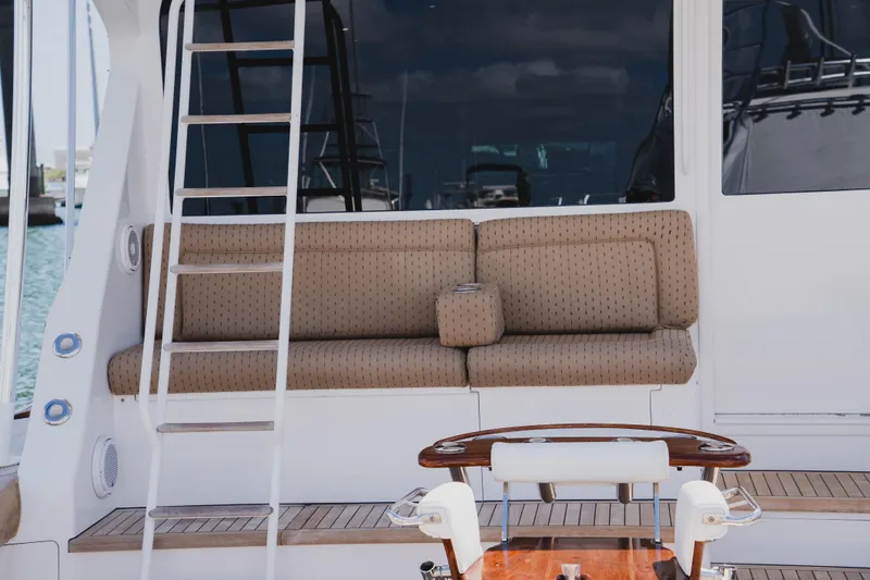 Slide: The Image of 1999 Viking 58 Convertible yacht with cushioned seating and ladder on deck. - 12