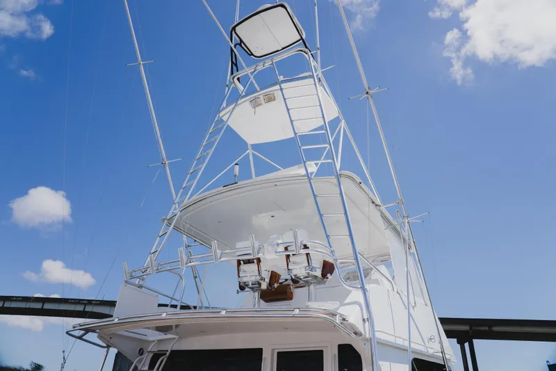 Slide: The Image of 1999 Viking 58 Convertible yacht with tower against a clear blue sky. - 14