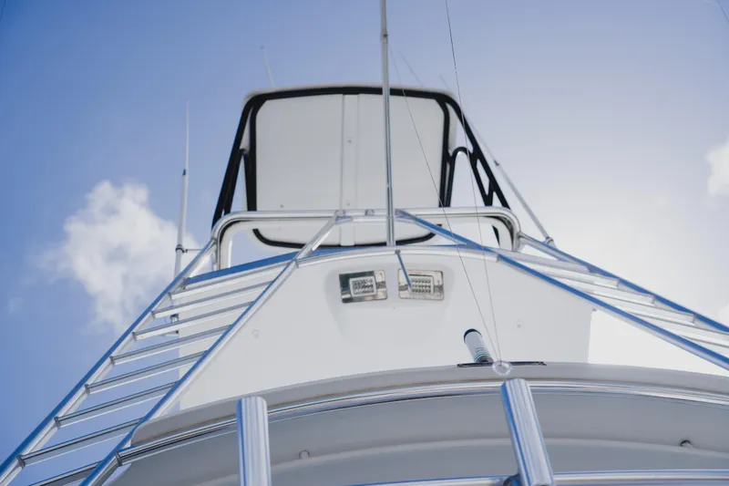 Slide: The Image of 1999 Viking 58 Convertible yacht, viewed from below against a clear blue sky. - 17