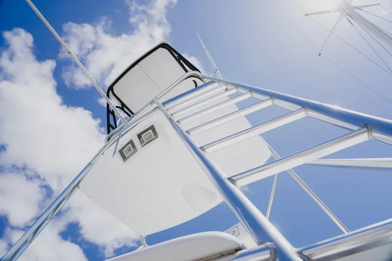 Slide: The Image of Ladder view on 1999 Viking 58 Convertible yacht against blue sky. - 18