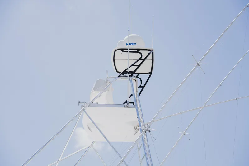 Slide: The Image of Radar and antenna setup on a 1999 Viking 58 Convertible yacht against a clear sky. - 19