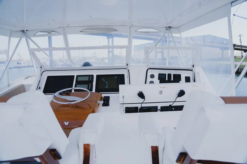 Slide: The Image of Interior view of a 1999 Viking 58 Convertible yacht cockpit with modern navigation equipment. - 22