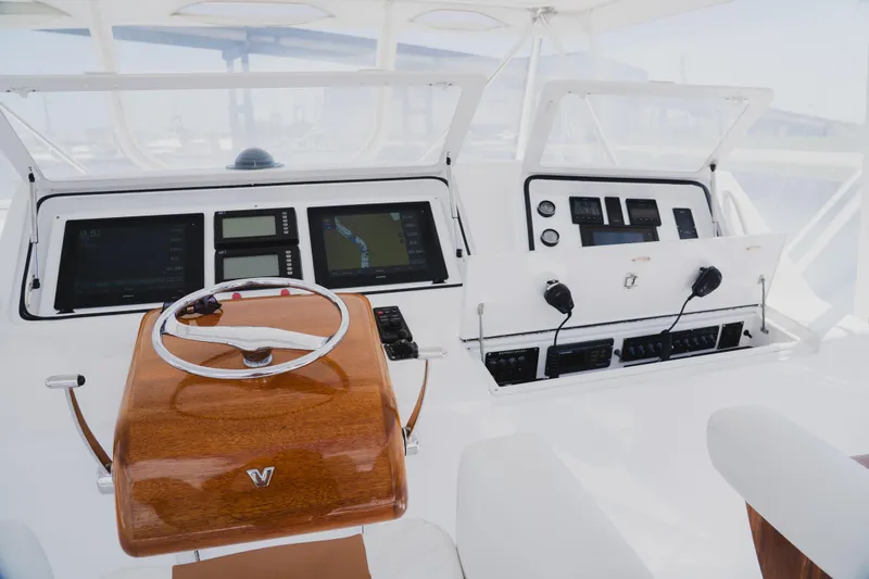 Slide: The Image of Cockpit of 1999 Viking 58 Convertible yacht with navigation instruments and wooden steering wheel. - 23